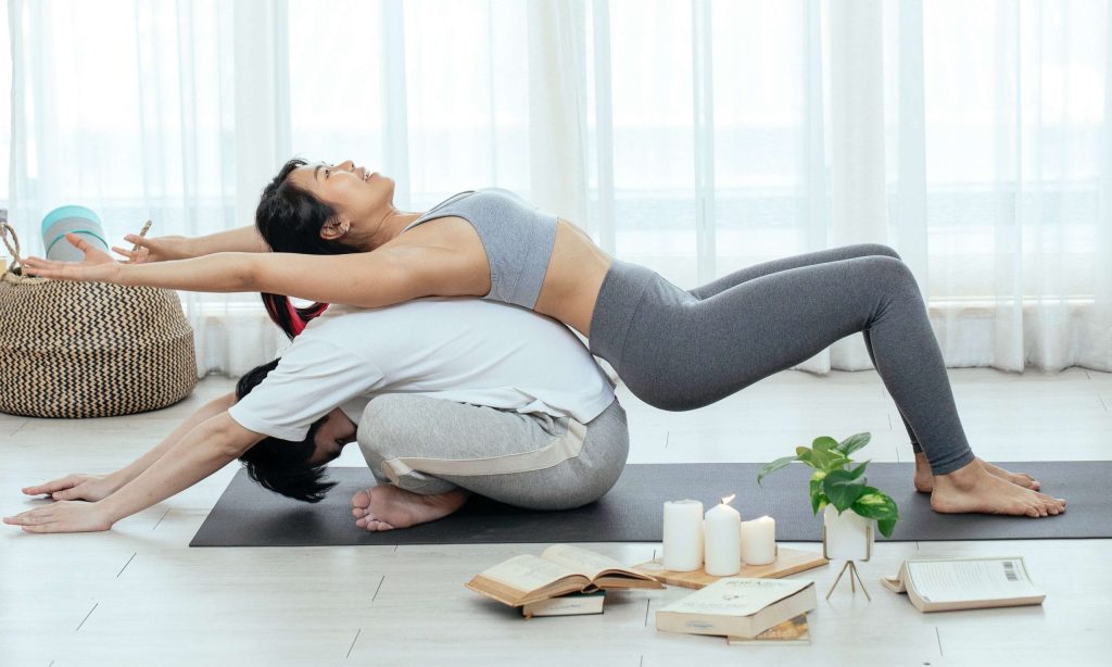 A person stretching or doing yoga in a cozy space with calming lighting.