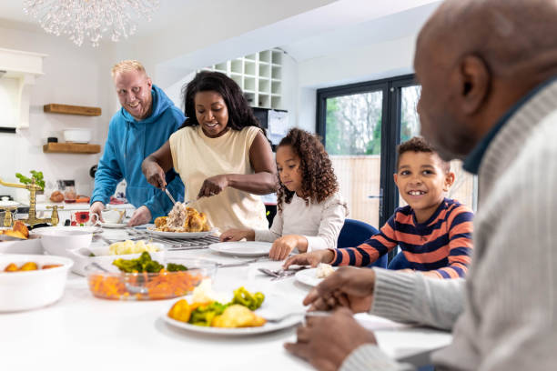 People enjoying a meal together, laughing, and engaging in a conversation.